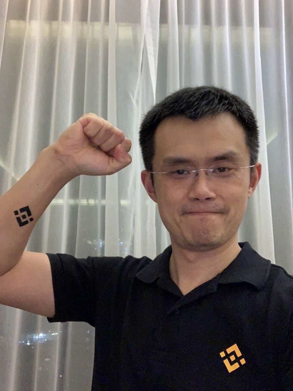 CZ flexing arm with Binance logo